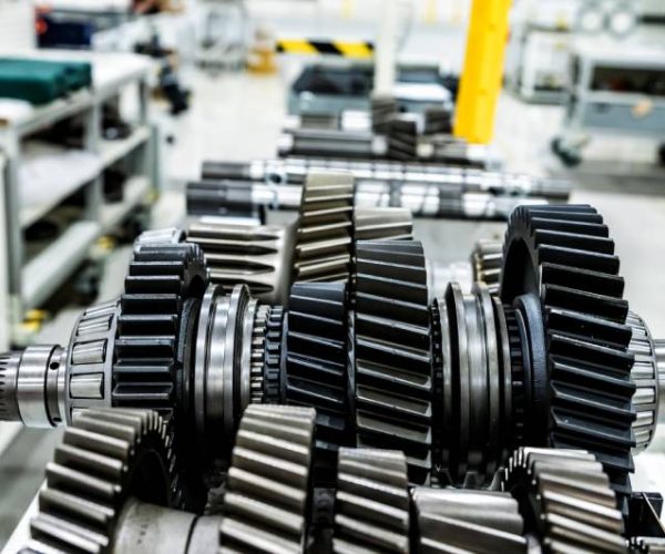 Close up disassembled tractor reduction axle on modern tractor at agricultural engineering industry. Selective focus.